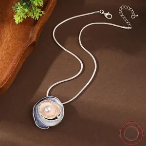 Elegant rose gold flower pendant necklace with enamel details and inlaid pearl
