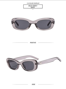 Detail of jelly gray oval sunglasses featuring silver star metal accents on temples
