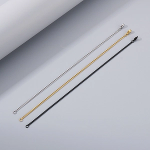 Close-up of minimalist stainless steel chains in gold, silver, and black finishes