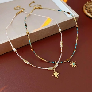 Detail of starburst pendants on bohemian beaded necklaces with turquoise accents