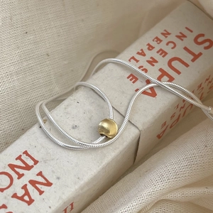 Minimalist 925 sterling silver snake chain necklace featuring a shiny gold bead pendant