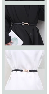 Detail of slim black leather belt with gold metal buckle styled on suit and dress