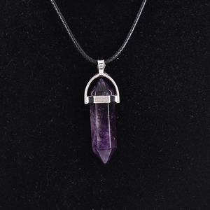Natural purple quartz point pendant necklace with silver metal cap on black silk background
