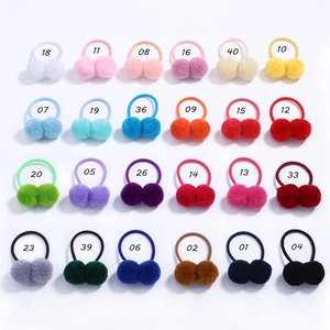 Detailed grid view of 24 colorful double pom-pom hair ties in diverse pastel and bright shades