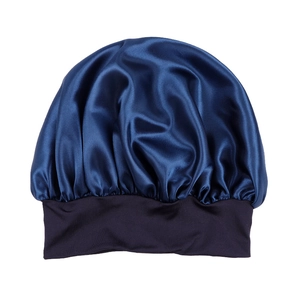 Detailed view of navy blue satin hair bonnet with wide black elastic head band