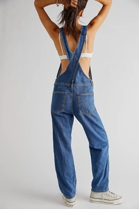 Rear view of loose-fit blue denim overalls with crisscross straps and large back pockets