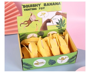 Macro view of realistic banana squishy toy in a retail display box with vibrant colors