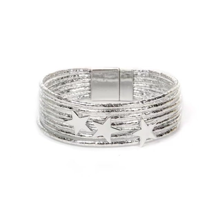 Close-up of silver leather wrap bracelet with triple star metal charms and magnetic clasp