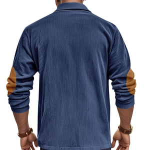 Detail view of navy corduroy shirt showing distinctive brown suede elbow patches and texture