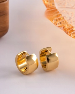 Macro shot of gold wide hoop earrings in polished stainless steel with vacuum plating