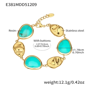 Detailed view of gold stainless steel bracelet with green resin drop charms and lobster clasp