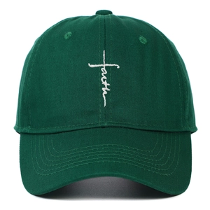 Close-up of white faith cross embroidery on dark green cotton twill baseball cap