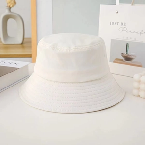 Detail shot of a white cotton bucket hat featuring multi-row stitching on the wide brim