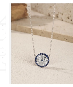 Macro detail of S925 sterling silver evil eye pendant with blue zircon stones