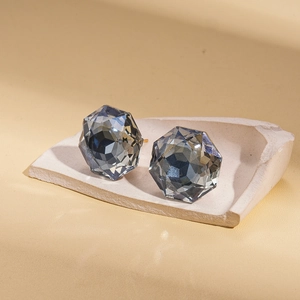 Minimalist geometric dark grey faceted glass stud earrings for women on a white stone base