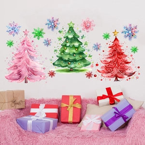 Detailed view of watercolor Christmas tree wall stickers with snowflakes on a white wall
