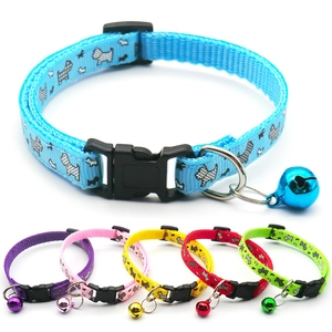 Detail of colorful nylon pet collars with bell, plastic buckle and dog pattern print