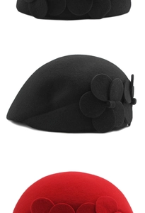 Close-up of wool beret showing layered petal floral details in black and red colors