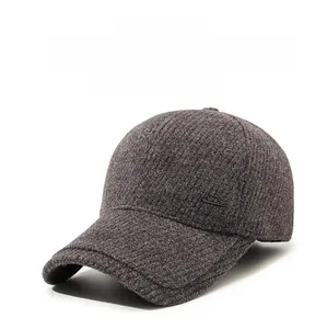 Close-up of thick knitted fabric texture and Narason metal logo on grey winter baseball cap