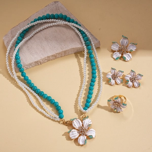Vintage layered flower jewelry set with pearls, turquoise beads, and crystals