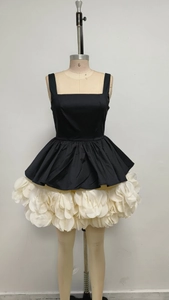 Detail of square neck bodice and 3D floral petal skirt on monochrome mini dress