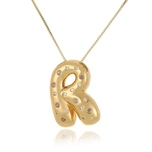 Macro shot of gold-plated letter R pendant with cubic zirconia on a delicate box chain