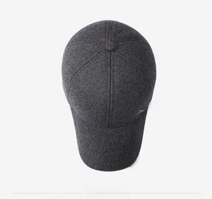 Overhead view of grey herringbone wool baseball cap with metallic side badge detail