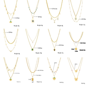 Set of 12 gold-layered necklaces featuring butterfly, star and turquoise pendants