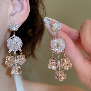 Close-up of pink flower tassel earrings with zircon stones and silver needles