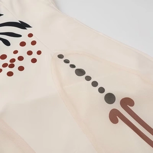 Detailed close-up of bohemian mesh print fabric with brown abstract geometric patterns