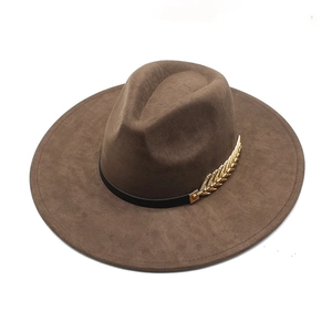 Detail of dark brown wool fedora hat featuring black band and golden wheat metal accent