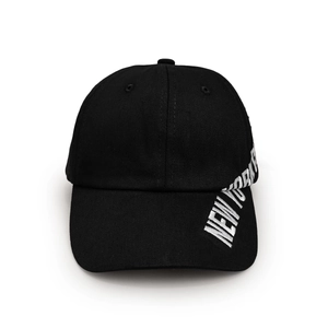 Detail of white NEW YORK CITY embroidery on the black cotton baseball cap side