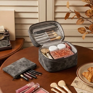 Dual-layer grey denim texture travel toiletry bag on wooden table with vintage decor