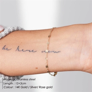 Detailed view of layered stainless steel chain bracelet on wrist with size specifications