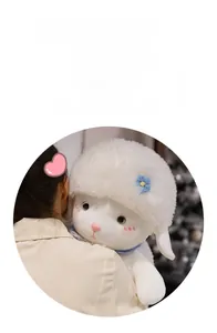 Close-up of cute plush lamb doll with a blue tie and floral headband for children