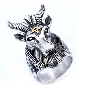 Vintage stainless steel ram head ring with golden pentagram detail on white background