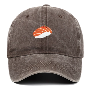 Detail of a sushi embroidery on a vintage washed cotton baseball cap with a worn texture