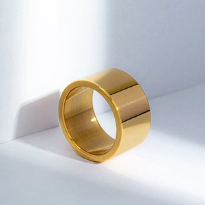 Polished 12mm wide gold titanium steel ring with minimalist brushed metal texture