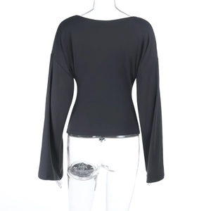 Rear view of slim fit black long sleeve top with waist shaping on transparent model