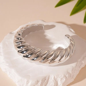 Gros plan du bracelet jonc ouvert argenté avec motifs de corde torsadée et textures