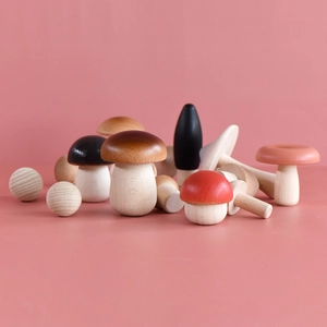 Creative hand-painted wooden mushroom ornaments set on a soft pink background