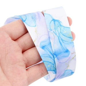 Detail of marble pattern lanyard with blue floral design and golden glitter finish