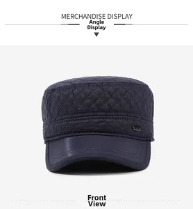 Front view of quilted navy flat top hat with metal logo and contrast faux leather brim