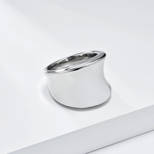 Close-up of minimalist polished silver wide ring with asymmetrical streamlined design