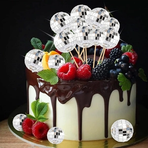 Silver mirror disco ball cake toppers in various sizes on a chocolate glazed cake