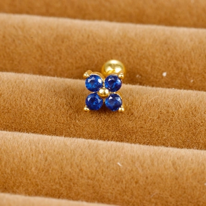 Macro shot of blue flower zircon stud earrings with gold screw back on velvet