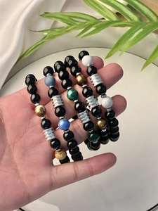 Detailed close-up of tiger eye and amethyst natural stone beaded bracelets for men