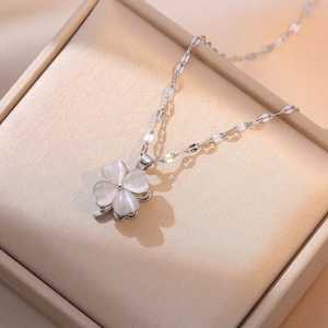 Silver titanium steel necklace with cat eye stone clover pendant in a beige jewelry box