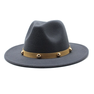 Close-up of gray wool fedora featuring mustard yellow band and gold rivet details