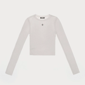 Close-up of a grey cropped knit top featuring a black cross logo and branded neck label